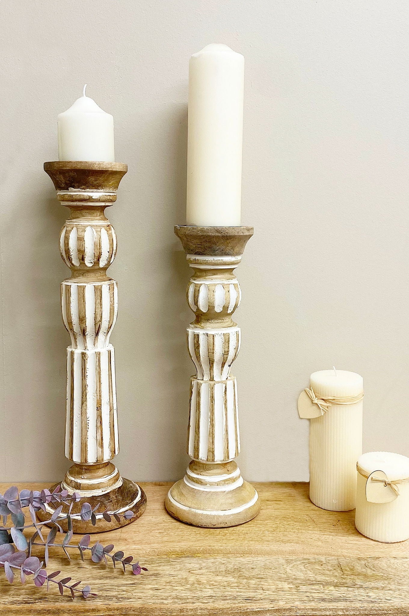 Geko Products wooden candle stick 45cm with white distressed finish holding white candles on wooden surface