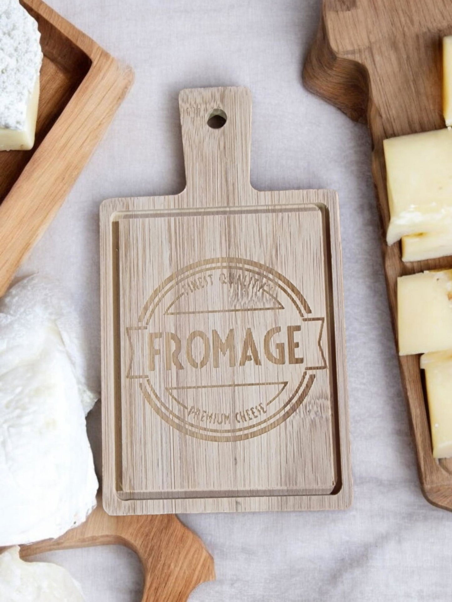 Geko Products wooden mini platter with fromage engraving surrounded by cheese and cheese boards