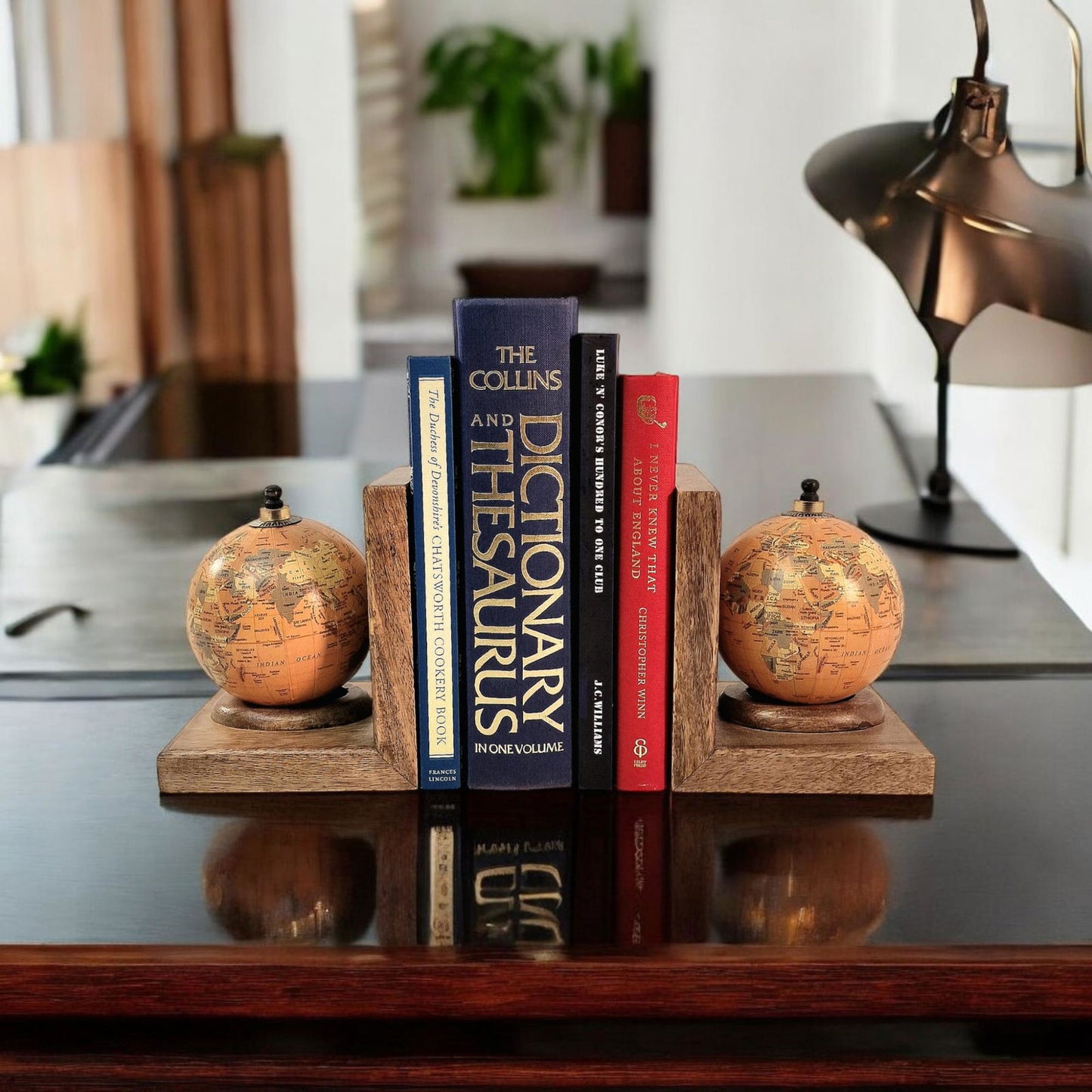 Geko Products world globe bookends set holding books on a wooden base on a polished table