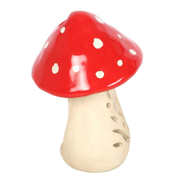 Vibrant red ceramic mushroom candle holder with white spots, perfect for tealight candles and home decor