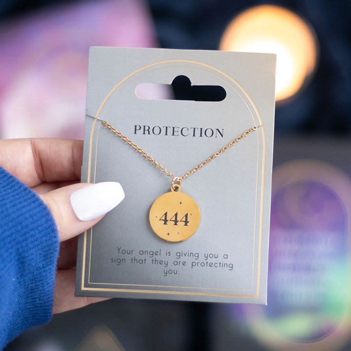 Gold 444 angel number necklace displayed on a card, symbolizing protection and spiritual guidance from angels