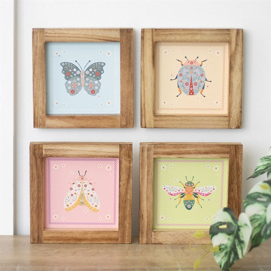 Nature inspired wall art set featuring four framed prints with colorful floral insects and butterflies against pastel backgrounds