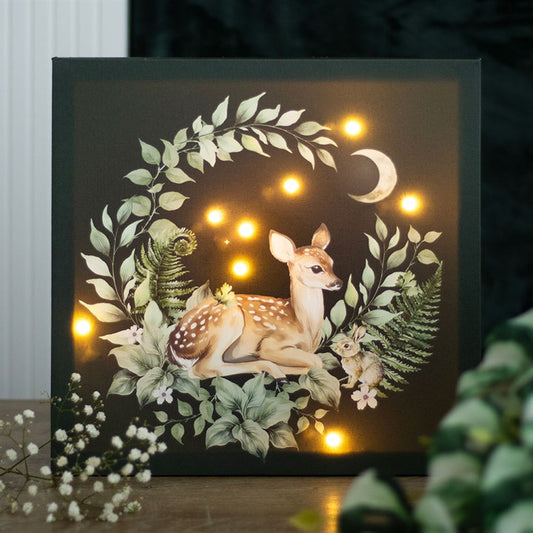 Light up fawn canvas plaque featuring a serene fawn surrounded by greenery and glowing lights, perfect for home decor