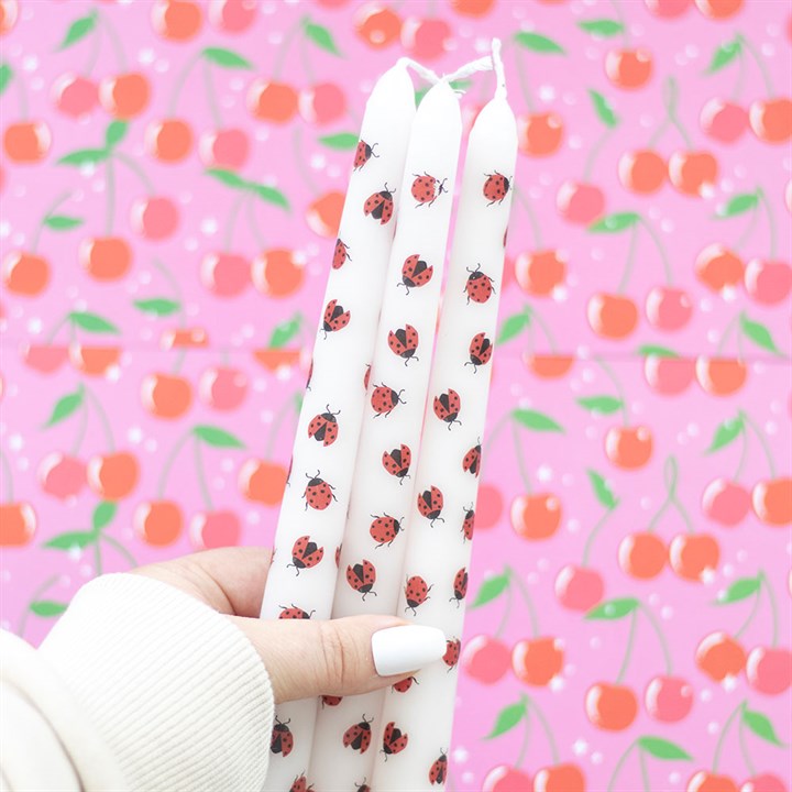Set of 3 ladybird candles featuring cute red ladybugs on a white taper design, perfect for home decor