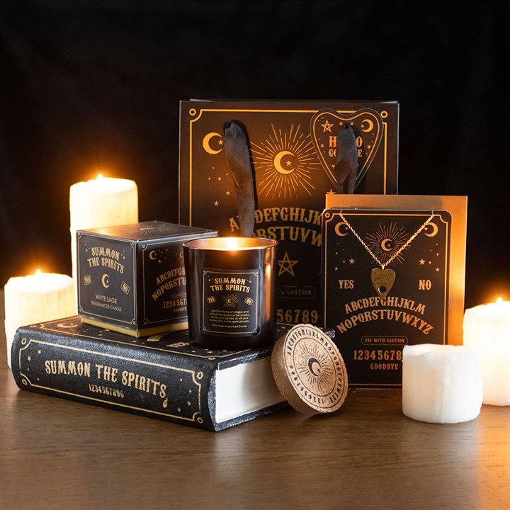 Occult-themed gift set with candles, necklace, and Ouija board elements.