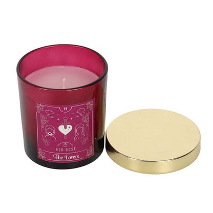 Lovers Tarot candle in a deep red glass jar with gold lid, featuring The Lovers artwork and soothing fragrance.