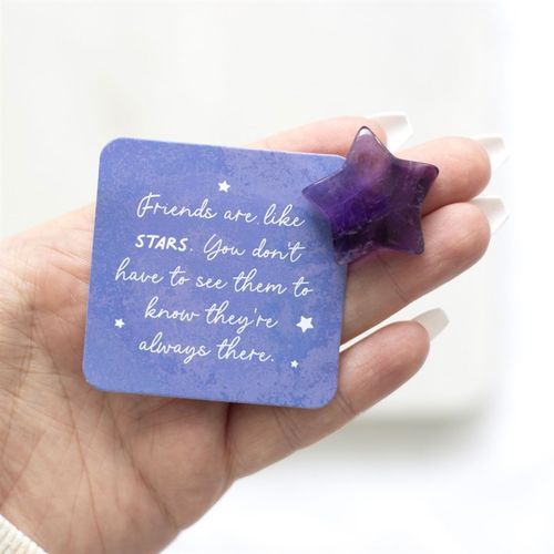 Amethyst crystal star gift with a motivational card in a hand