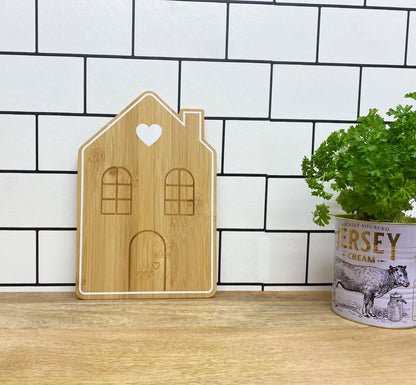 Geko Products bamboo house serving tray with heart and window design standing on wooden surface
