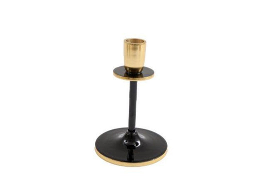 Black and gold candlestick with round base and metallic finish