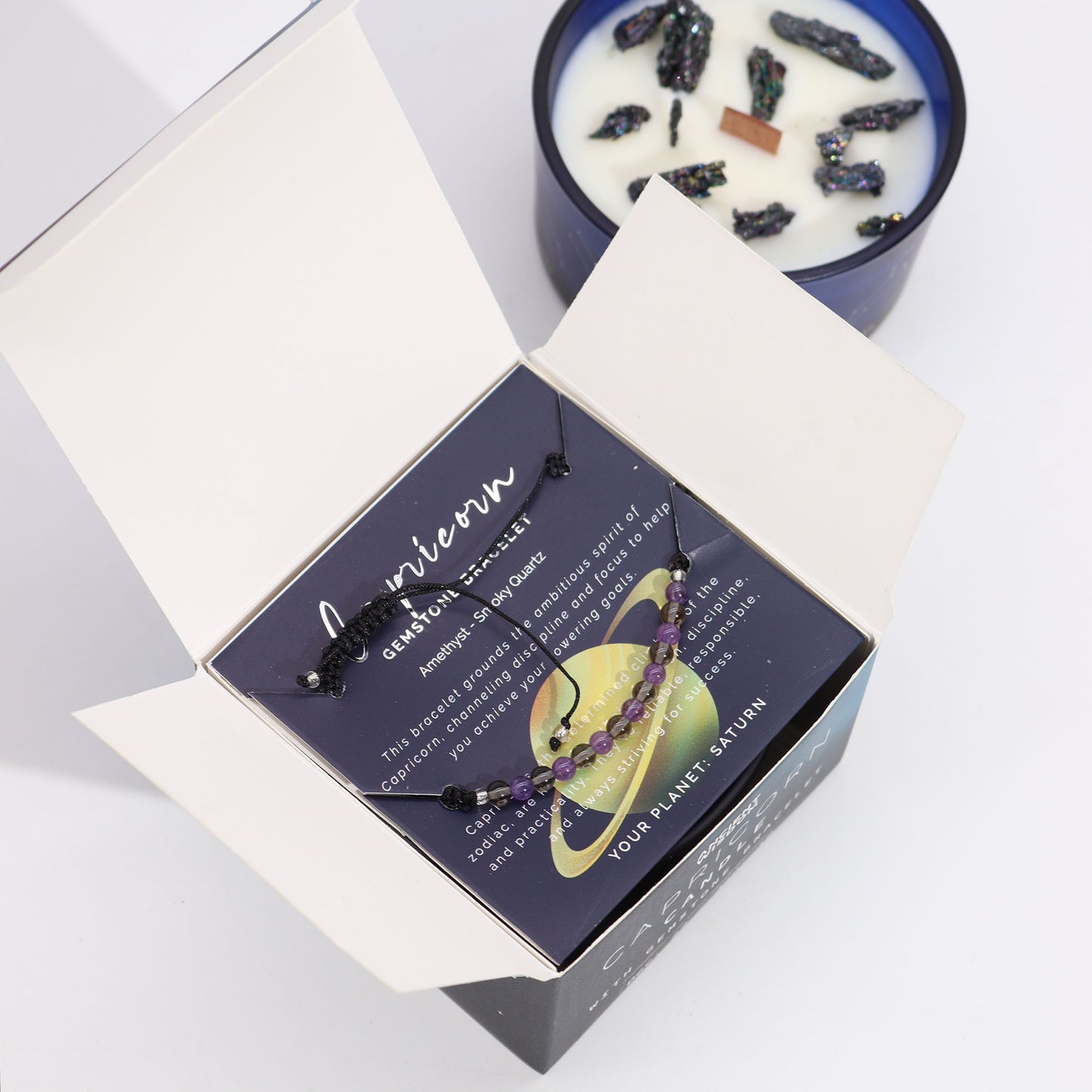 Capricorn gemstone bracelet nestled in a box with Zodiac Crystal Candle