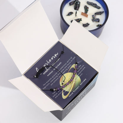 Capricorn gemstone bracelet nestled in a box with Zodiac Crystal Candle