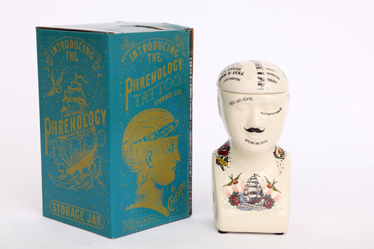 Geko Products ceramic phrenology head jar with vintage tattoo design next to blue storage box