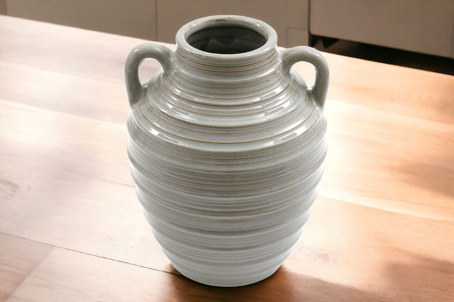 Geko Products ceramic ribbed vase with handles in neutral tones placed on wooden surface