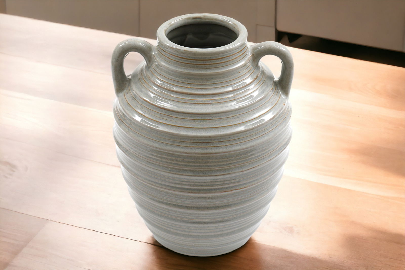 Geko Products ceramic ribbed vase with handles in neutral tones placed on wooden surface