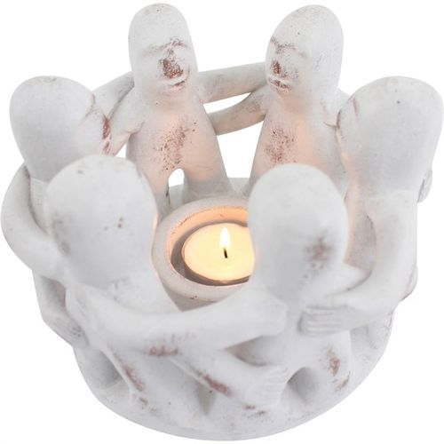 Circle of Friends candle holder featuring unique design with figures embracing around a tealight for spiritual decor