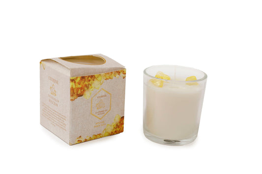 Geko Products Citrine Glass Candlepot with white wax and yellow citrine stones beside decorative packaging box