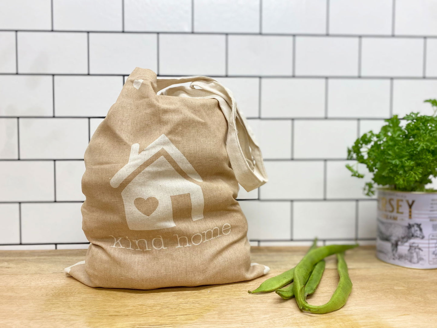 Geko Products eco-friendly tote bag with kind home design on kitchen counter next to green beans