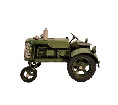 Green metal tractor ornament with detailed vintage design and large rear wheels