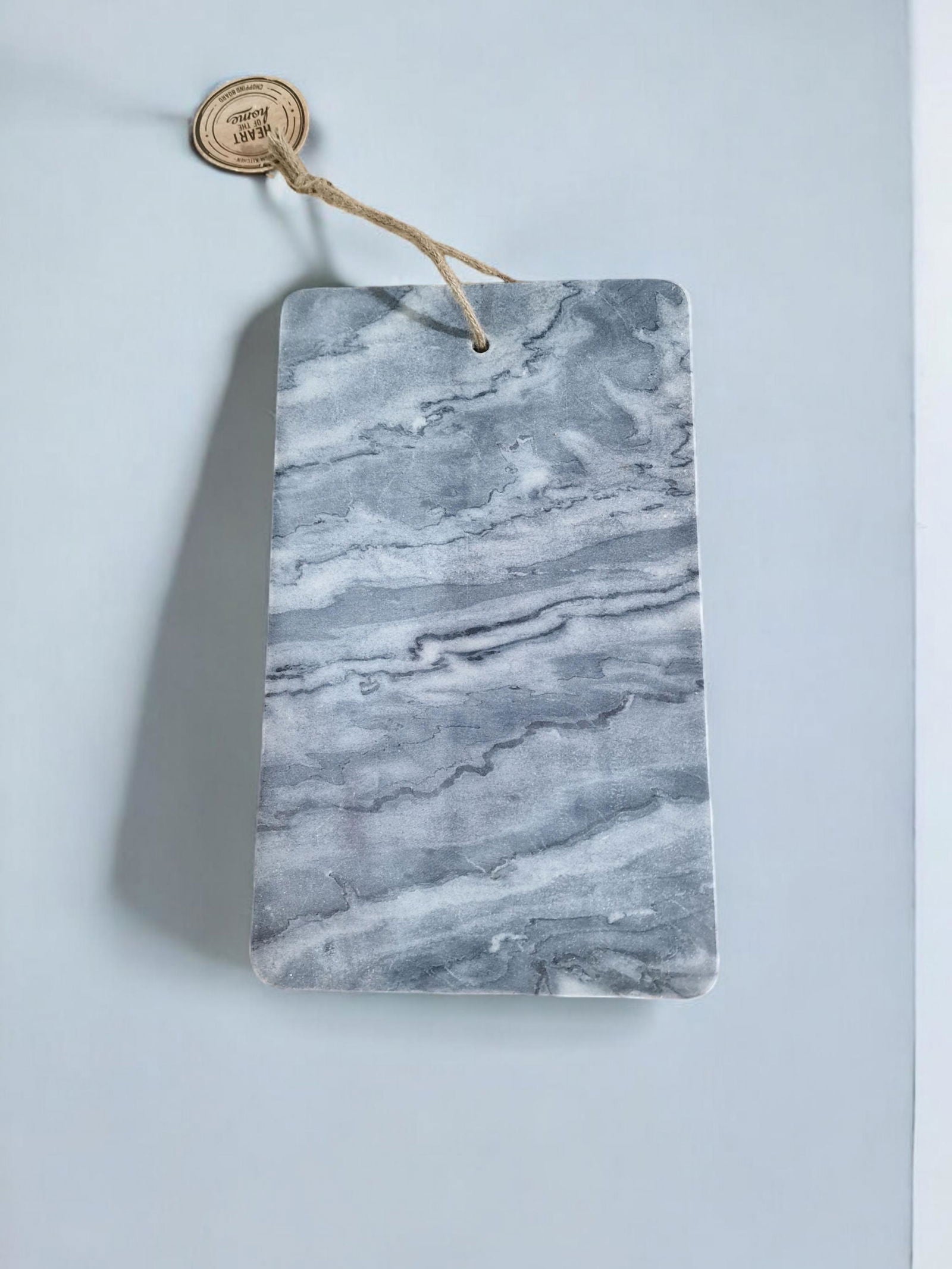 Grey marble chopping board with natural stone texture and hanging rope by Geko Products