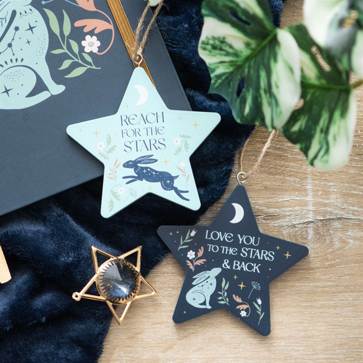 Colorful Reach for the Stars decoration hanging in a cozy setup with celestial designs