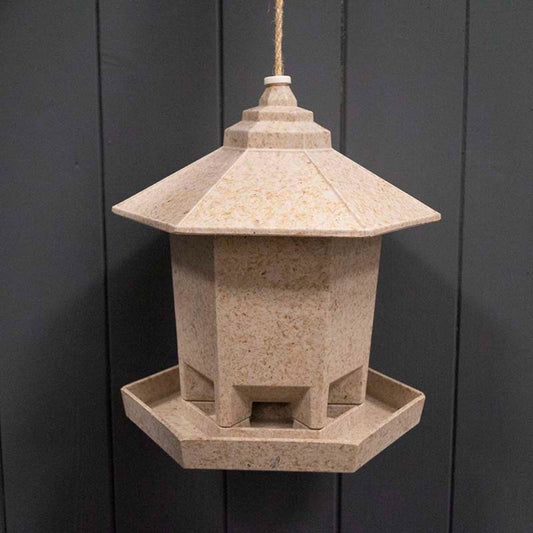 Hexagonal bird feeder earthy design by Geko Products hanging with natural wood texture
