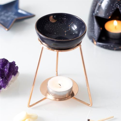 Purple star sign oil burner on a stylish metal base for relaxing aromatherapy