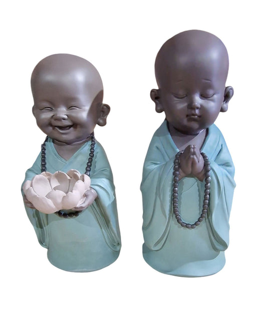 Large Buddha statue set featuring two serene figures in blue robes holding prayer beads and a lotus flower