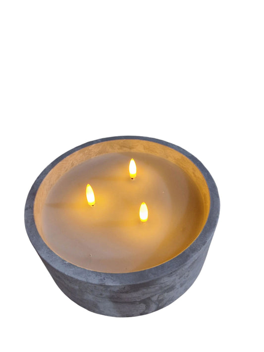 LED cement candle holder with three glowing LED flames in a round gray cement base