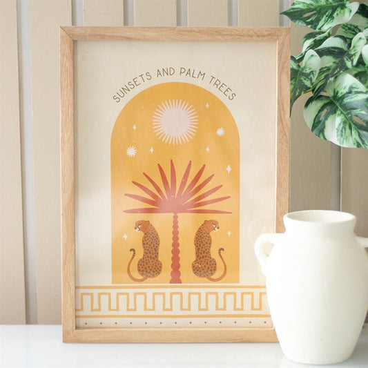 Leopard wall art print featuring two leopards and a palm tree in a warm sunset theme