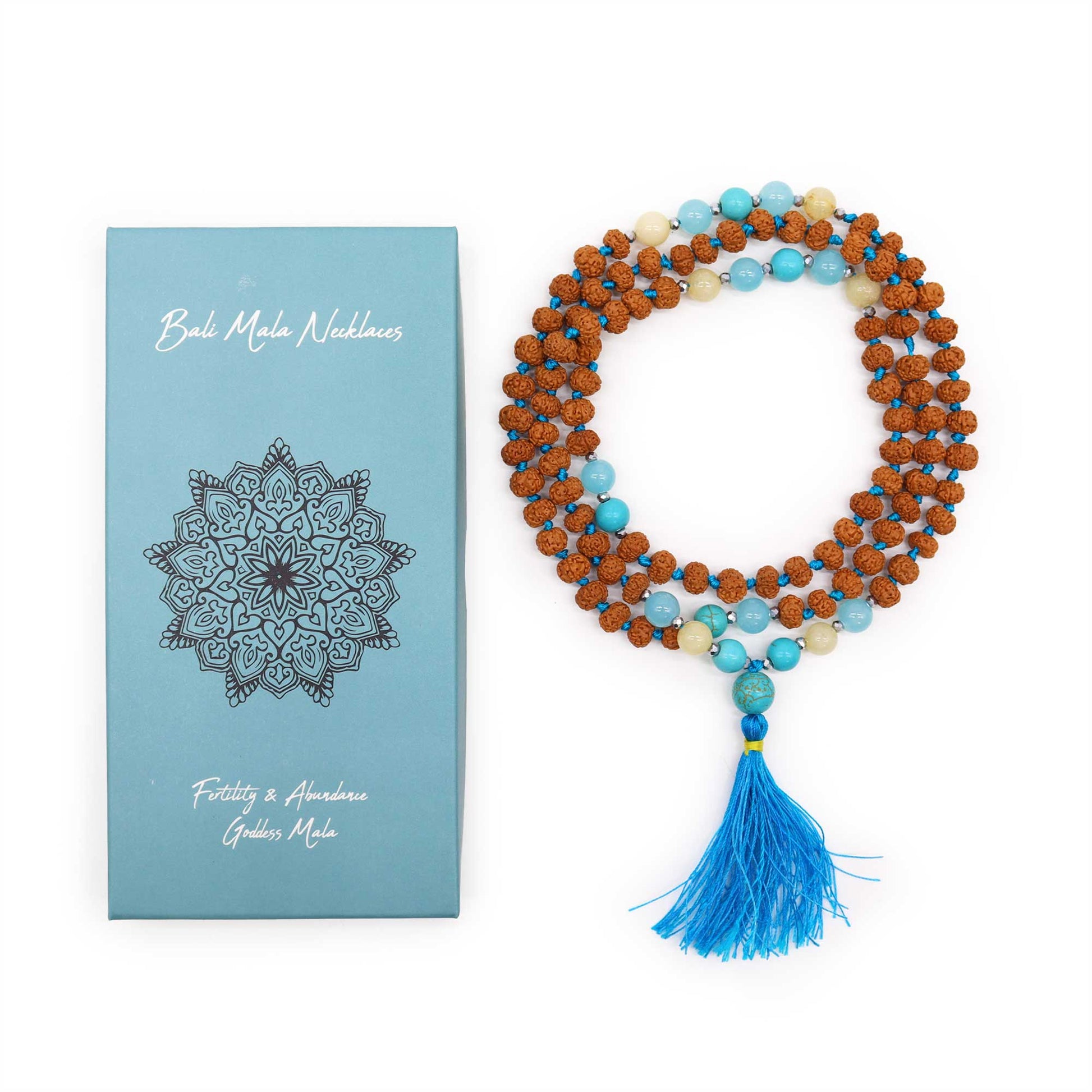 Mala necklace for fertility featuring wooden beads, turquoise accents, and a blue tassel, in decorative packaging