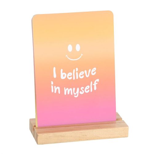 Mindful affirmation cards with I believe in myself message on pink and orange gradient card in wooden stand
