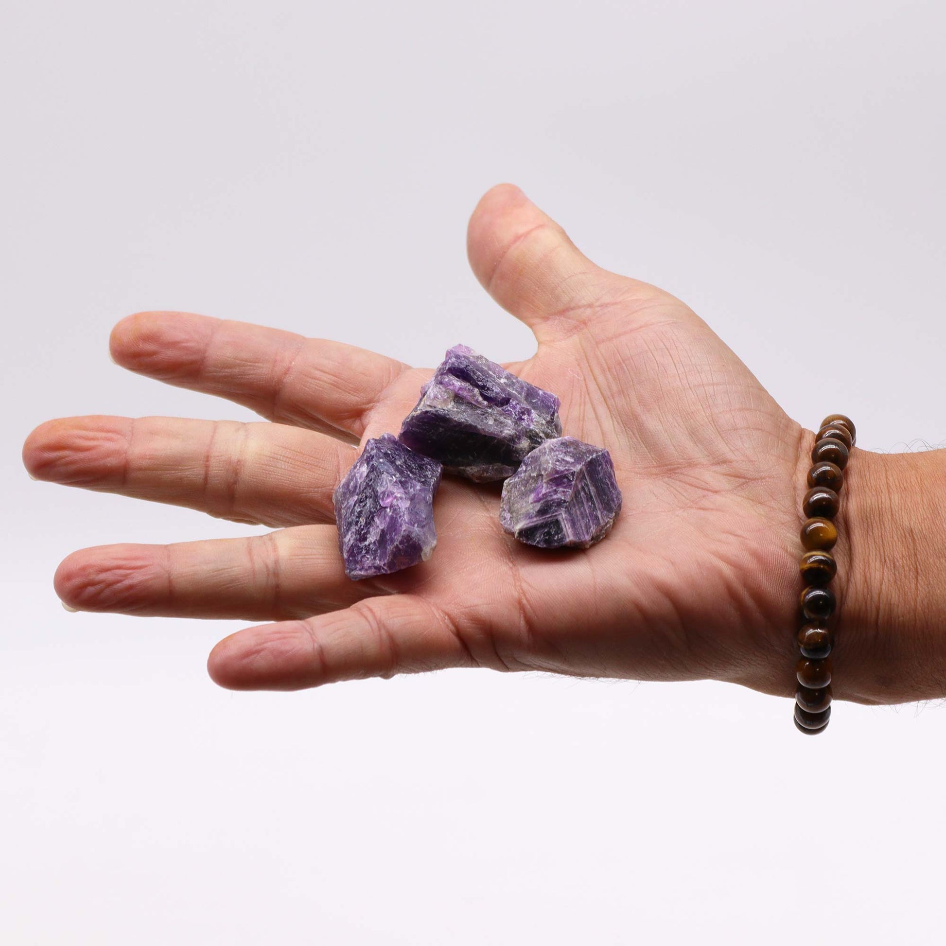 Unpolished Amethyst raw crystals with rich violet tones, perfect for meditation, Reiki, and crystal grid setups.
