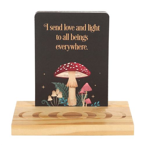 Reiki affirmation cards displayed on a wooden stand with a colorful mushroom design and inspirational message