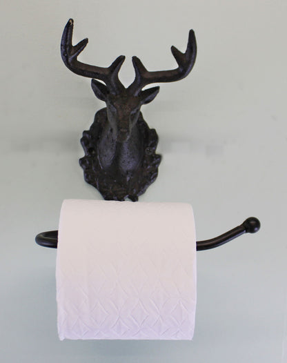 Rustic stag head toilet roll holder in dark metal mounted on wall holding white toilet paper roll