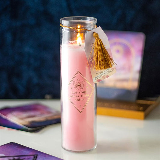 Mystic rose tube candle in a clear glass holder, adorned with rose quartz crystals and a golden tassel tag, promoting inner light