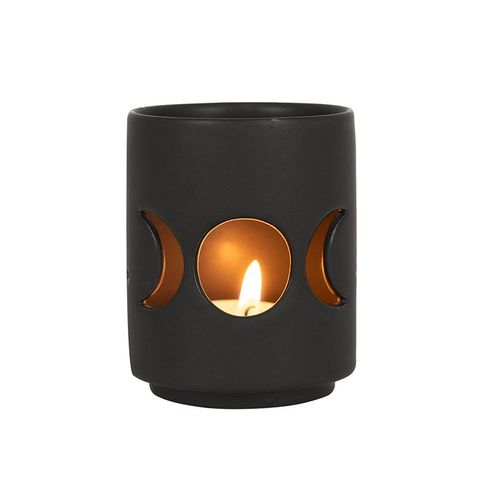 Small decorative tealight holder with stylish design featuring crescent moon cutouts for a cozy ambiance
