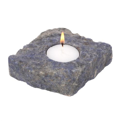 Sodalite Tealight Holder with a candle, showcasing its unique blue stone texture for spiritual ambiance