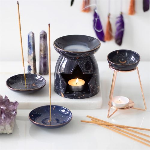 Purple star sign oil burner on a metal base with incense sticks and matching dishes displayed
