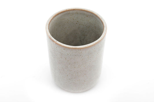Taupe ceramic toothbrush holder by Geko Products with a smooth speckled finish