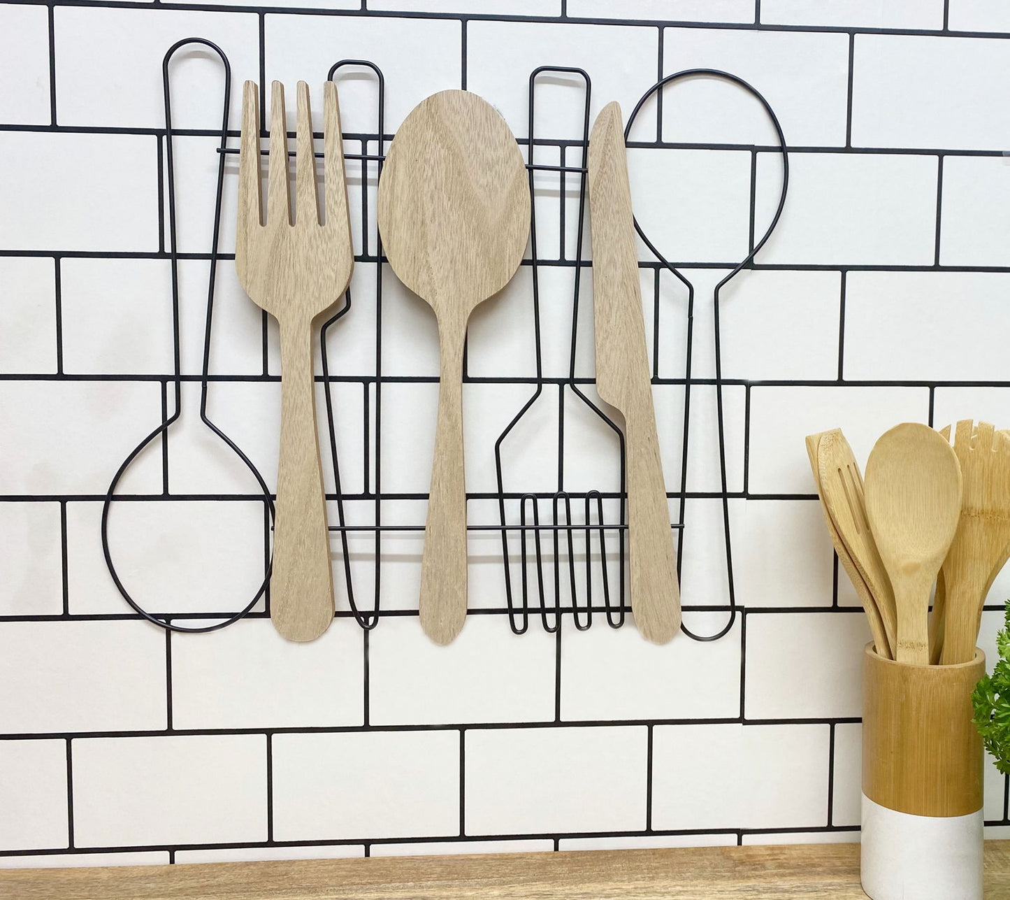 Geko Products unique cutlery wall art featuring wooden fork spoon and knife decor on a white tiled wall