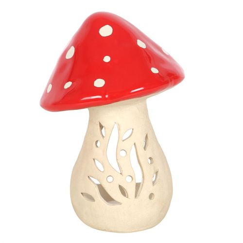 Ceramic mushroom candle holder with a vibrant red cap and intricate cut-out designs for tealight candles, ideal for cozy decor.