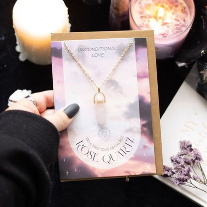 Elegant rose quartz crystal necklace and card featuring the phrase 'Unconditional Love' for spiritual connection and healing.