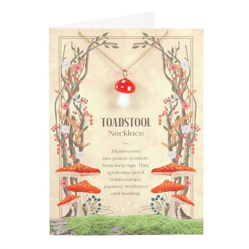 Toadstool charm necklace displayed on a decorative card featuring red mushroom illustrations and a poetic description