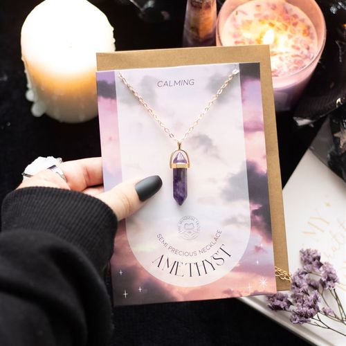 An amethyst crystal necklace card featuring a pendant, with calming colors and a decorative background, labeled as Amethyst Crystal Card