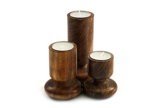 Geko Products wooden candlestick set featuring three different sized polished dark wood holders with white candles